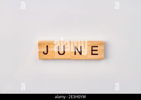 June word written on wooden blocks. Stock Photo