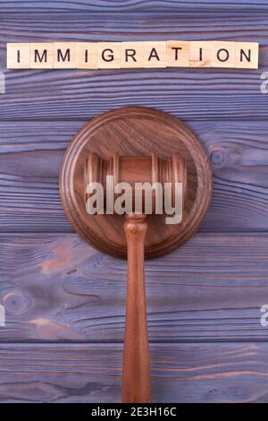 Immigration law wooden gavel. Stock Photo
