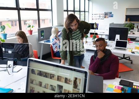 Two diverse businessmen working in creative office Stock Photo