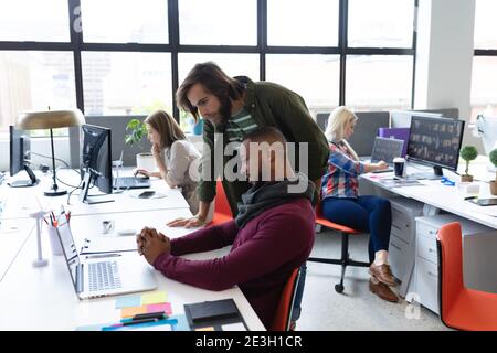 Two diverse businessmen working in creative office Stock Photo