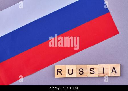 Flag of Russian isolated on violet background. Stock Photo