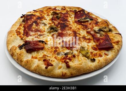 Italian Pizza with speck, mushrooms and provolone cheese Stock Photo