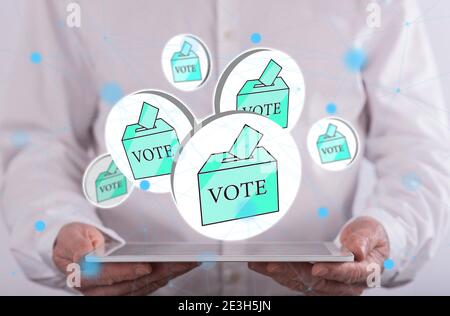 Vote concept above a tablet held by a man in background Stock Photo