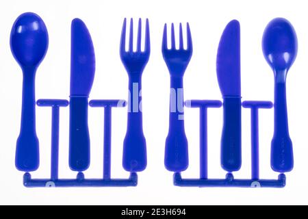 Plastic cutlery, spoon, knife, fork, still on the cast iron strand, children's cutlery, Stock Photo