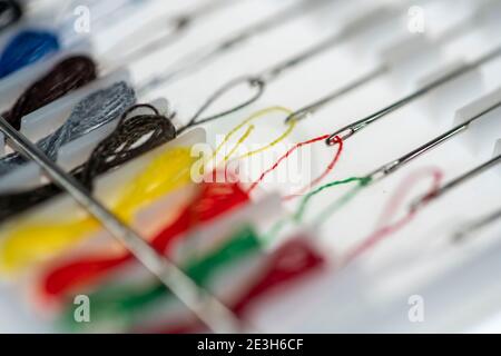 Sewing kit, sewing thread and sewing needles, already threaded, different colours, ready to sew, hotel amenities, Stock Photo