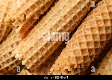 Tasty wafer rolls with condensed milk, close up Stock Photo