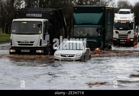 Hathern, Leicestershire, UK. 19th January 2021. UK weather. Lorries are driven past a car stranded in flood water. Storm Christoph is set to bring widespread flooding to parts of England. Credit Darren Staples/Alamy Live News. Stock Photo