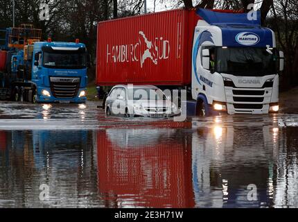 Hathern, Leicestershire, UK. 19th January 2021. UK weather. Lorries are driven past a car stranded in flood water. Storm Christoph is set to bring widespread flooding to parts of England. Credit Darren Staples/Alamy Live News. Stock Photo