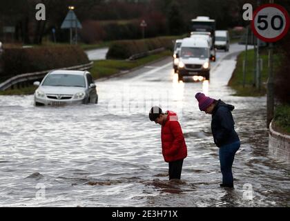 Hathern, Leicestershire, UK. 19th January 2021. UK weather. Children paddle near a car stranded in flood water. Storm Christoph is set to bring widespread flooding to parts of England. Credit Darren Staples/Alamy Live News. Stock Photo