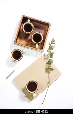 Mango wood wooden tray with four espresso coffee cups on the white background. Empty space Stock Photo
