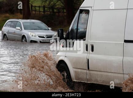 Hathern, Leicestershire, UK. 19th January 2021. UK weather. A dog looks from a van driving past a car stranded in flood water. Storm Christoph is set to bring widespread flooding to parts of England. Credit Darren Staples/Alamy Live News. Stock Photo