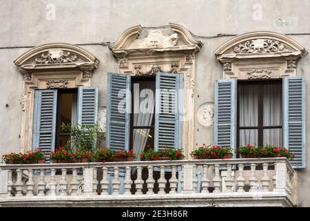 Old  windows with  wooden shutters and curtain in Italy Stock Photo