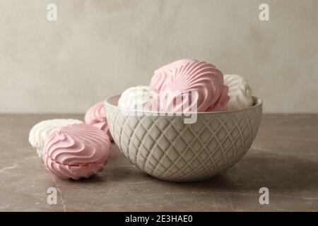 Bowl with sweet marshmallow on gray table Stock Photo