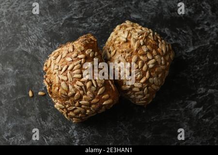 Fresh baked rye buns on black smokey table Stock Photo