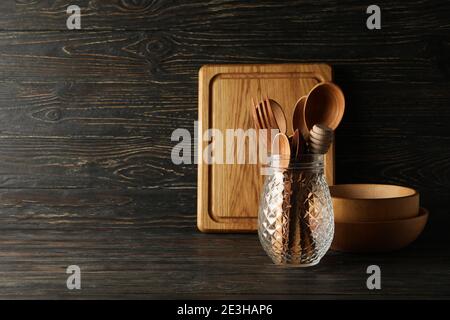 Different wooden kitchenware on wooden background, space for text Stock Photo