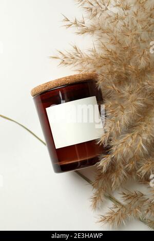 Scented candle and reed on white background Stock Photo
