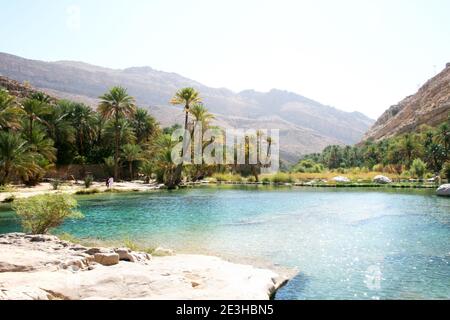 Beautiful emerald fresh water pools of the Oasis Wadi Bani Khalid in Oman Stock Photo