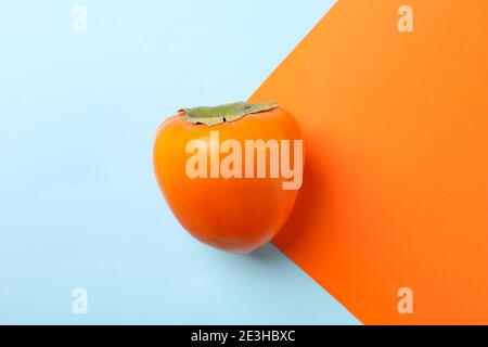 Fresh ripe persimmon on two tone background Stock Photo
