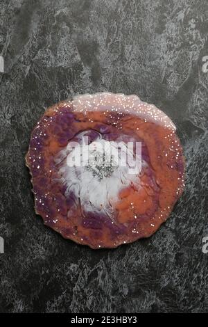 Abstract epoxy resin art on a dark smoky backdrop, a top view of glossy epoxy resin with smoky swirls for a moody texture background Stock Photo