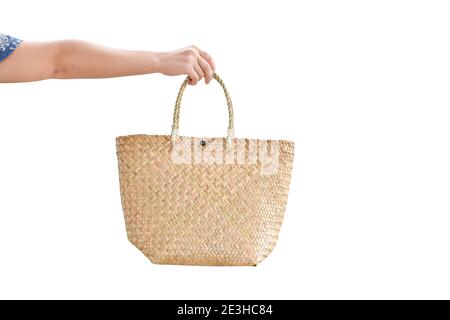 Woman hand holding straw bag, isolated on white background. with clipping path. Stock Photo