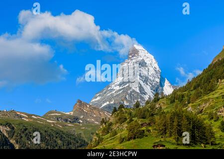 White clouds form above the iconic Matterhorn mountain viewed from Zermatt, Valais (Wallis), Switzerland Stock Photo