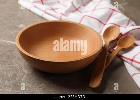 Kitchen napkin with wooden dishes on gray table Stock Photo