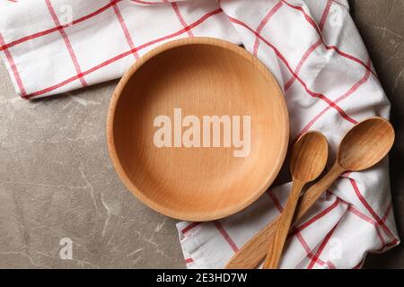 Kitchen napkin with wooden dishes on gray table Stock Photo