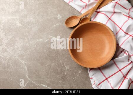 Kitchen napkin with wooden dishes on gray table Stock Photo
