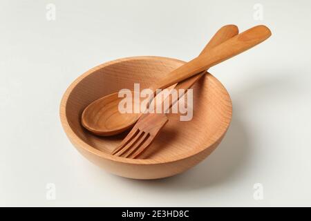 Wooden bowl with fork and spoon on white background Stock Photo