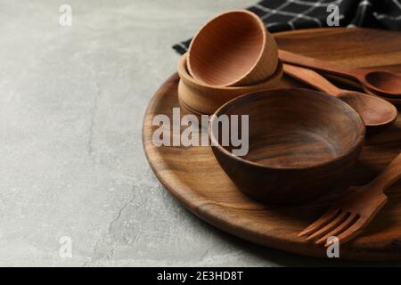 Towel and wooden kitchenware on gray table Stock Photo