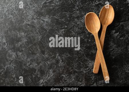 Wooden spoons on black smokey background, space for text Stock Photo
