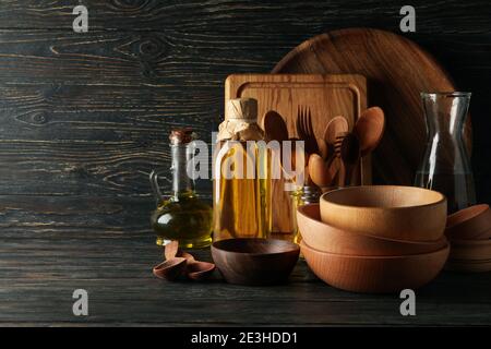 Different wooden kitchenware on wooden table, space for text Stock Photo