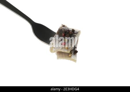 Fork with fresh herring fish isolated on white background Stock Photo