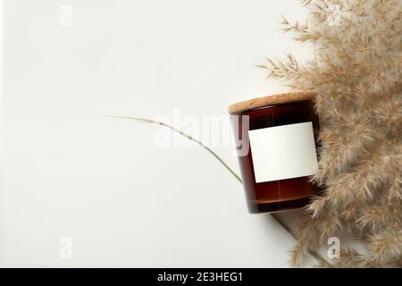 Scented candle and reed on white background Stock Photo