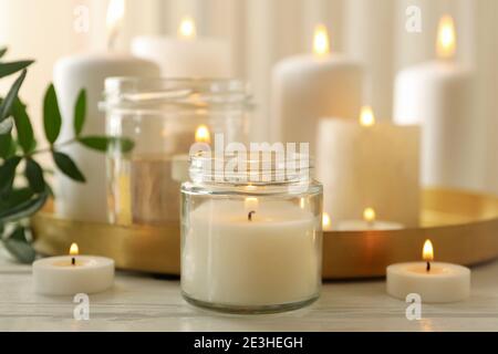Burning scented candles for relax on white wooden table Stock Photo