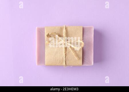 Piece of natural soap on violet background Stock Photo