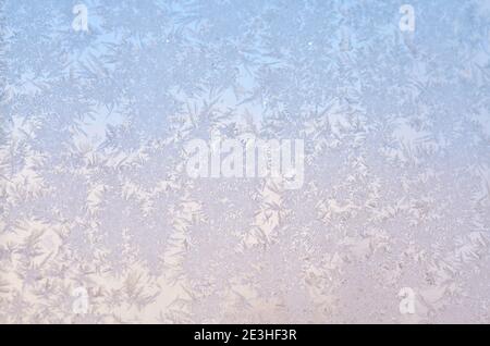 Winter ice frost on the glass as a light blue background Stock Photo