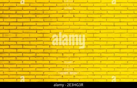 Colorful brick wall, bright yellow vintage style of brickwork background paint with texture details. Stock Photo