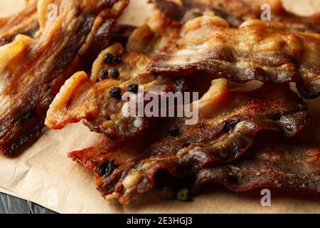 Baking paper with fried bacon and pepper Stock Photo