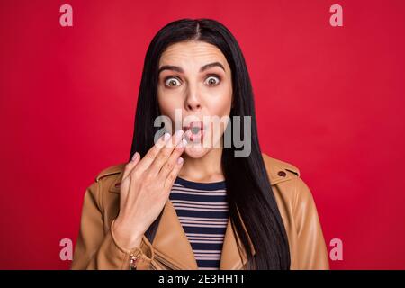 Photo of shocked person arm near mouth cant believe wear striped jumper isolated on red color background Stock Photo