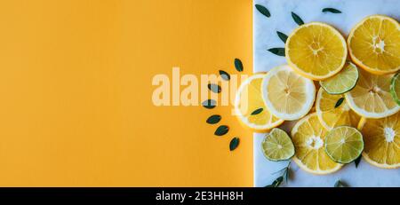 Web size banner of various citrus fruits isolated on yellow background Stock Photo