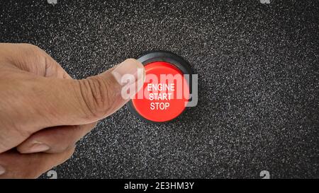 Close up on the finger pressing a button that indicates the start of the engine or electrical equipment. Stock Photo