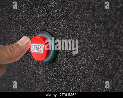 Close up on the finger pressing a button that indicates the start of the engine or electrical equipment. Stock Photo
