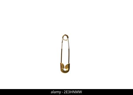 One golden safety pin isolated on white background Stock Photo