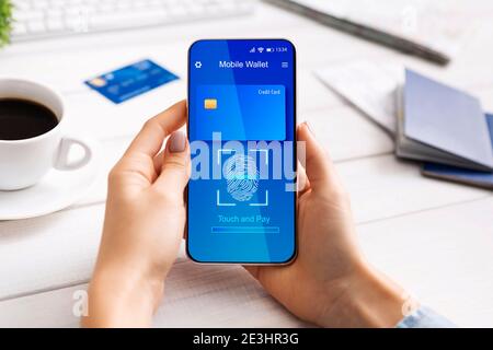 Unrecognizable Lady Using Mobile Wallet App Via Phone At Workplace Stock Photo