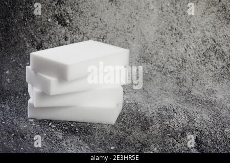 Melamine household sponge. Melamine sponges on dark background, tools for kitchen and home cleaning Stock Photo