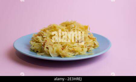 Stewed white cabbage on a plate. A dish of Russian, Polish cuisine. Garnish in the USSR. Stock Photo