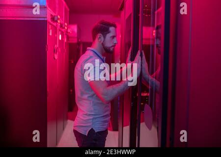 Man opening closet in data center Stock Photo