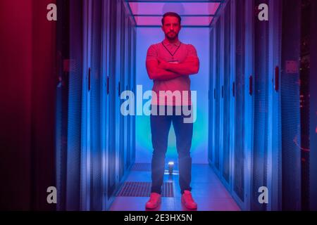 Confident programmer standing in the data center Stock Photo