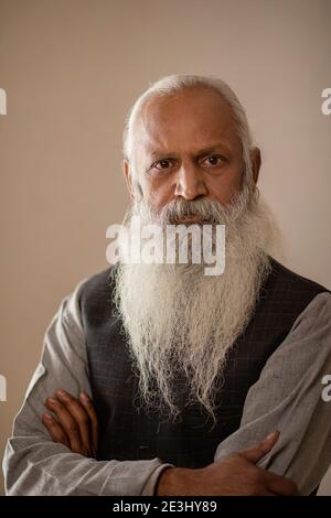 PORTRAIT OF A BEARDED OLD MAN LOOKING STRAIGHT AT CAMERA Stock Photo